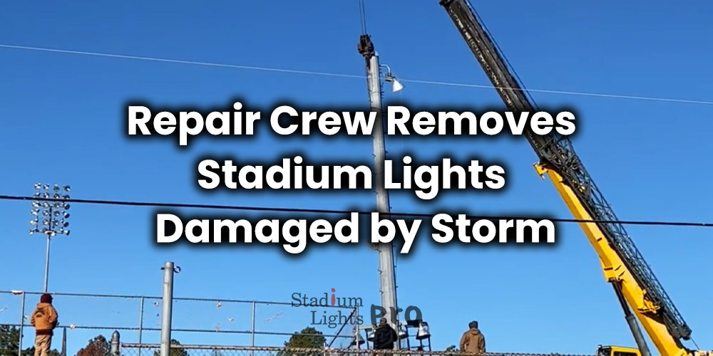 repair crew removes stadium lights damaged by storm